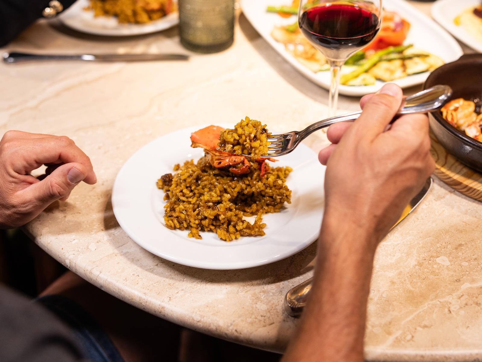 Amigos comiendo arroz de marisco en La Taberna de Peñalver, Cava Baja